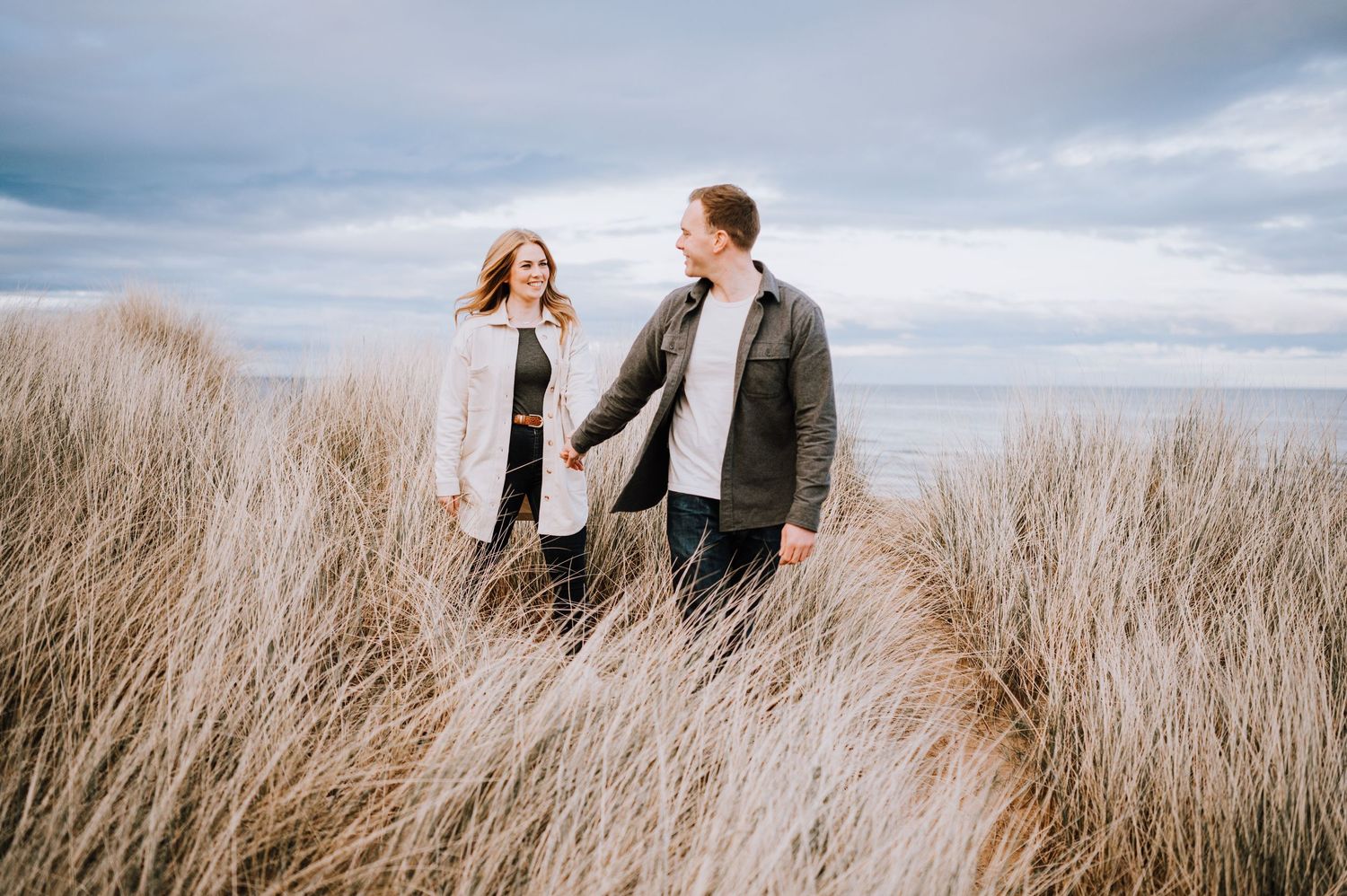 Couple shares a tender moment during their coastal photoshoot.