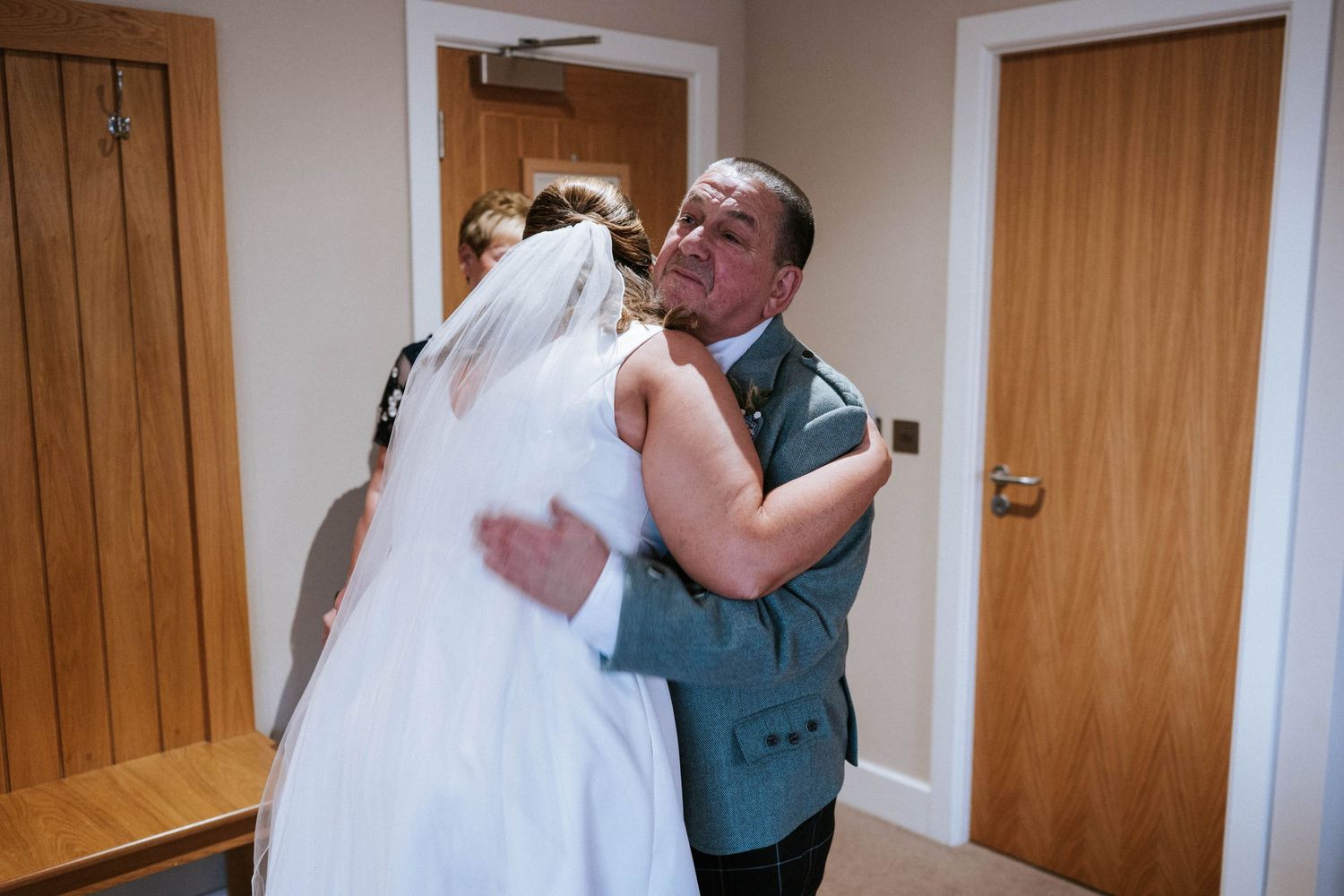 Indoor wedding venue with natural wood doors and warm lighting creating an intimate atmosphere.