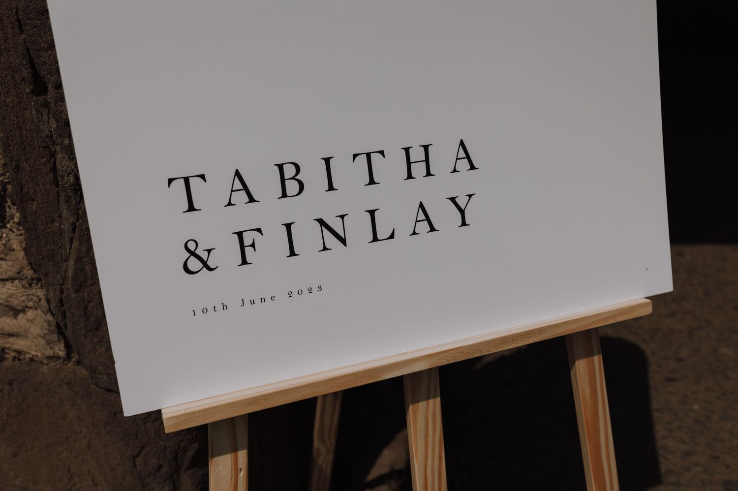 Modern minimalist wedding sign displaying Tabitha & Finlay on white board.