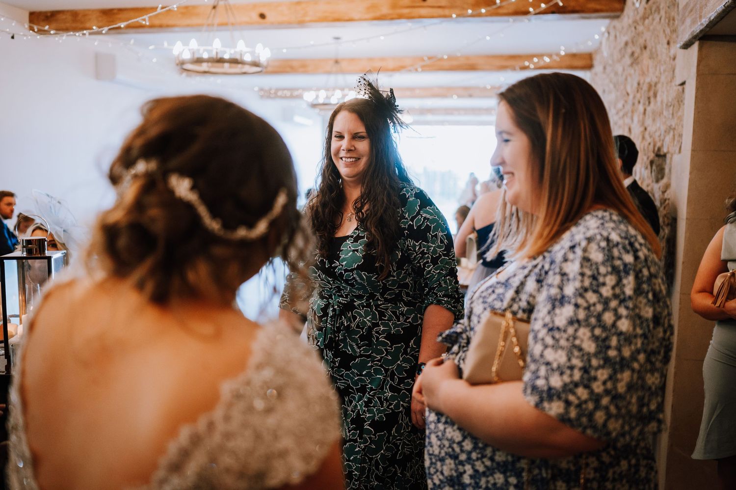 Wedding celebration with guests socializing and sharing joyful moments.