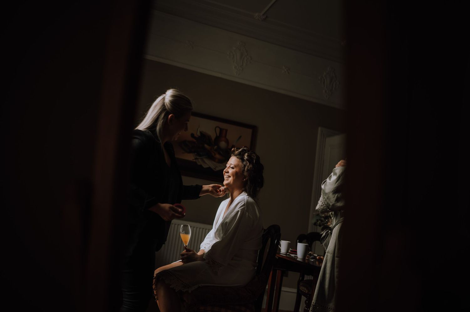 A dark and moody getting-ready scene with hair styling preparations.