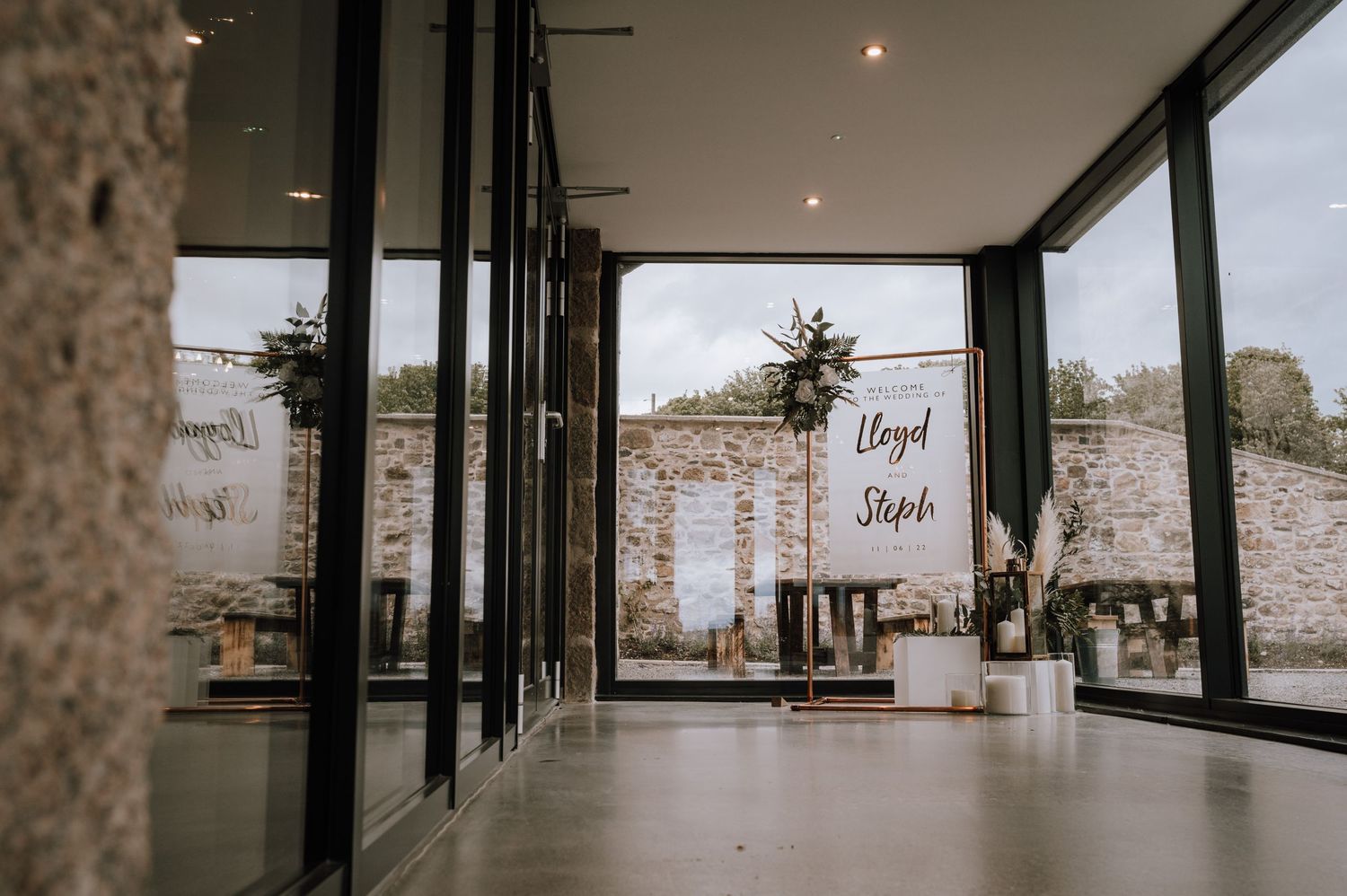 Modern wedding venue with floor-to-ceiling windows and elegant signage.