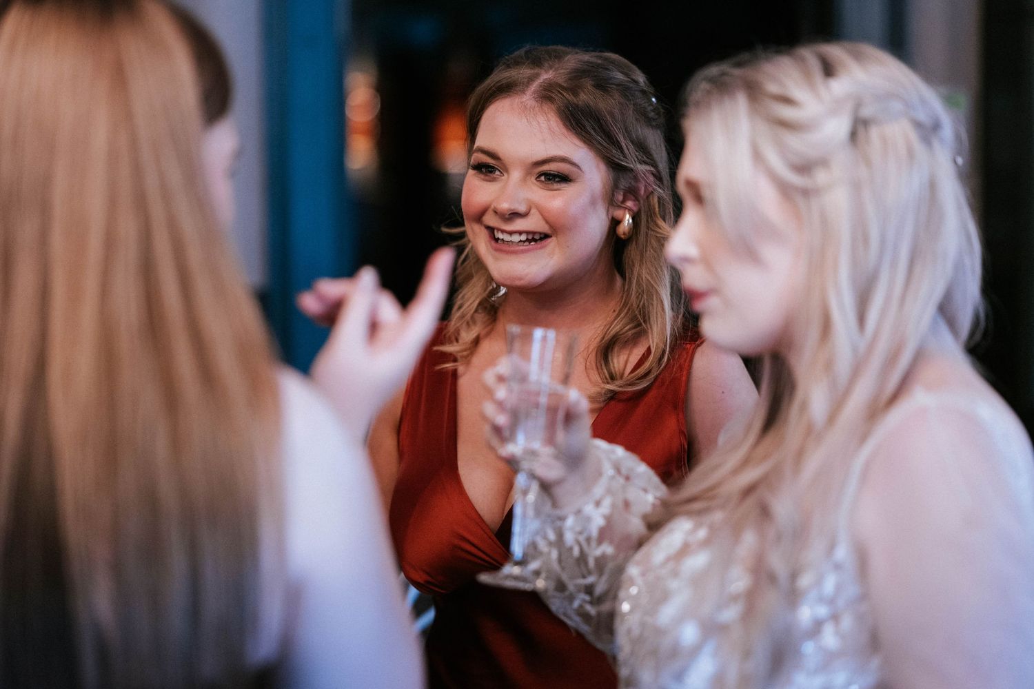 Wedding guests enjoying conversation and champagne at reception.