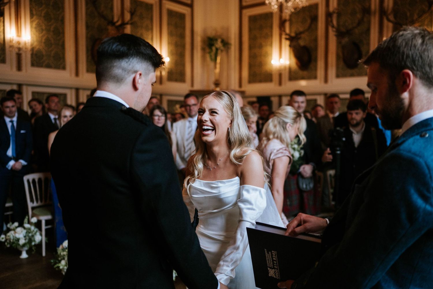 Wedding guests dancing and celebrating on an elegant dance floor during an evening reception.