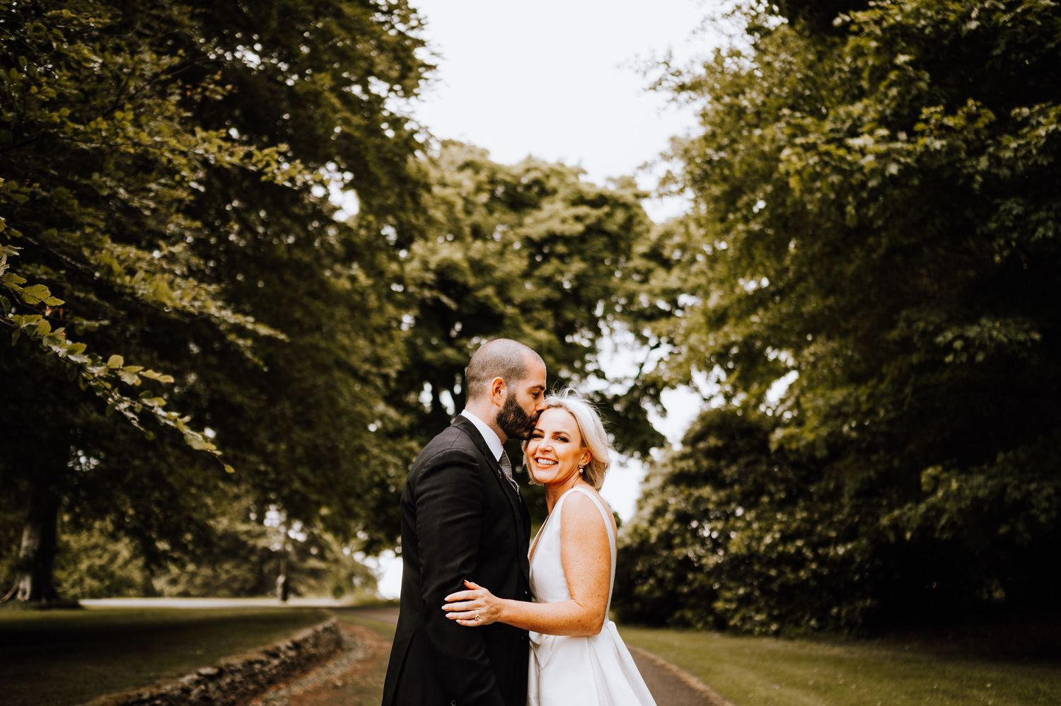 Aberdeen Wedding Photography. Newlyweds share tender moments during outdoor wedding photo session.