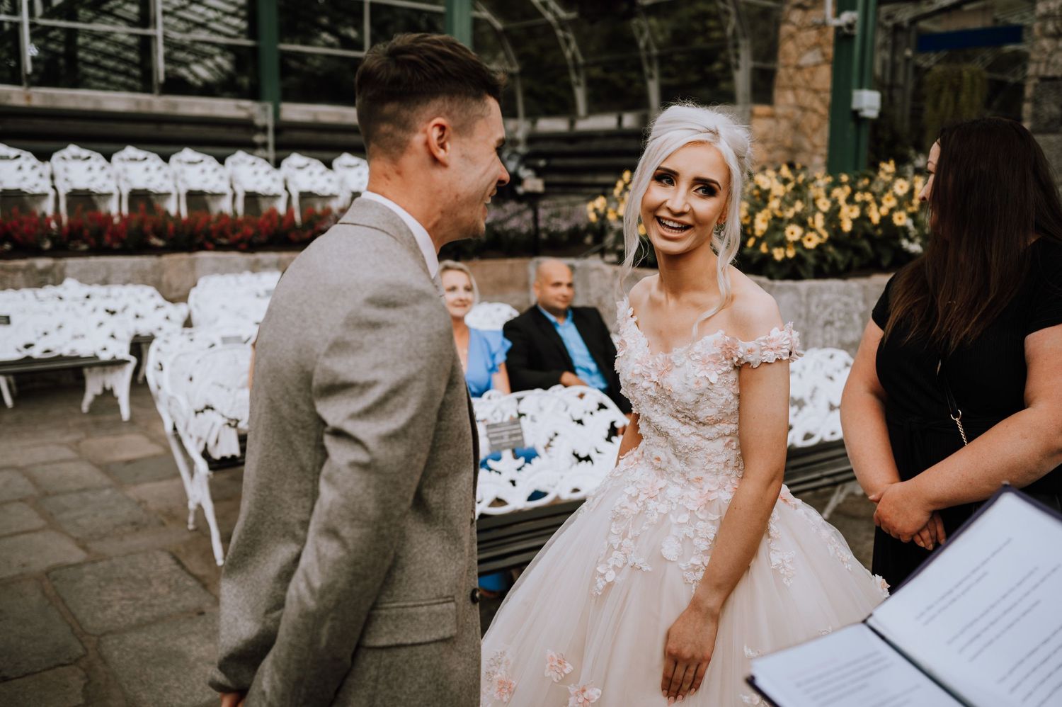 A happy interaction during a greenhouse wedding ceremony.
