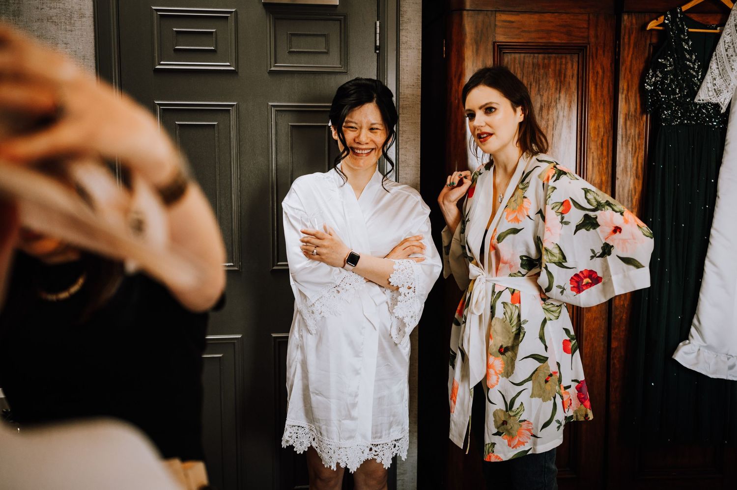 Wedding preparation moment with people in robes getting ready in a bedroom.