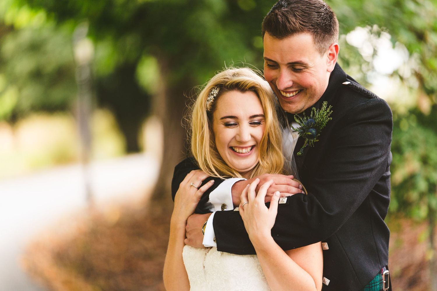 Romantic wedding couple portraits on a garden path with Scottish wedding attire.