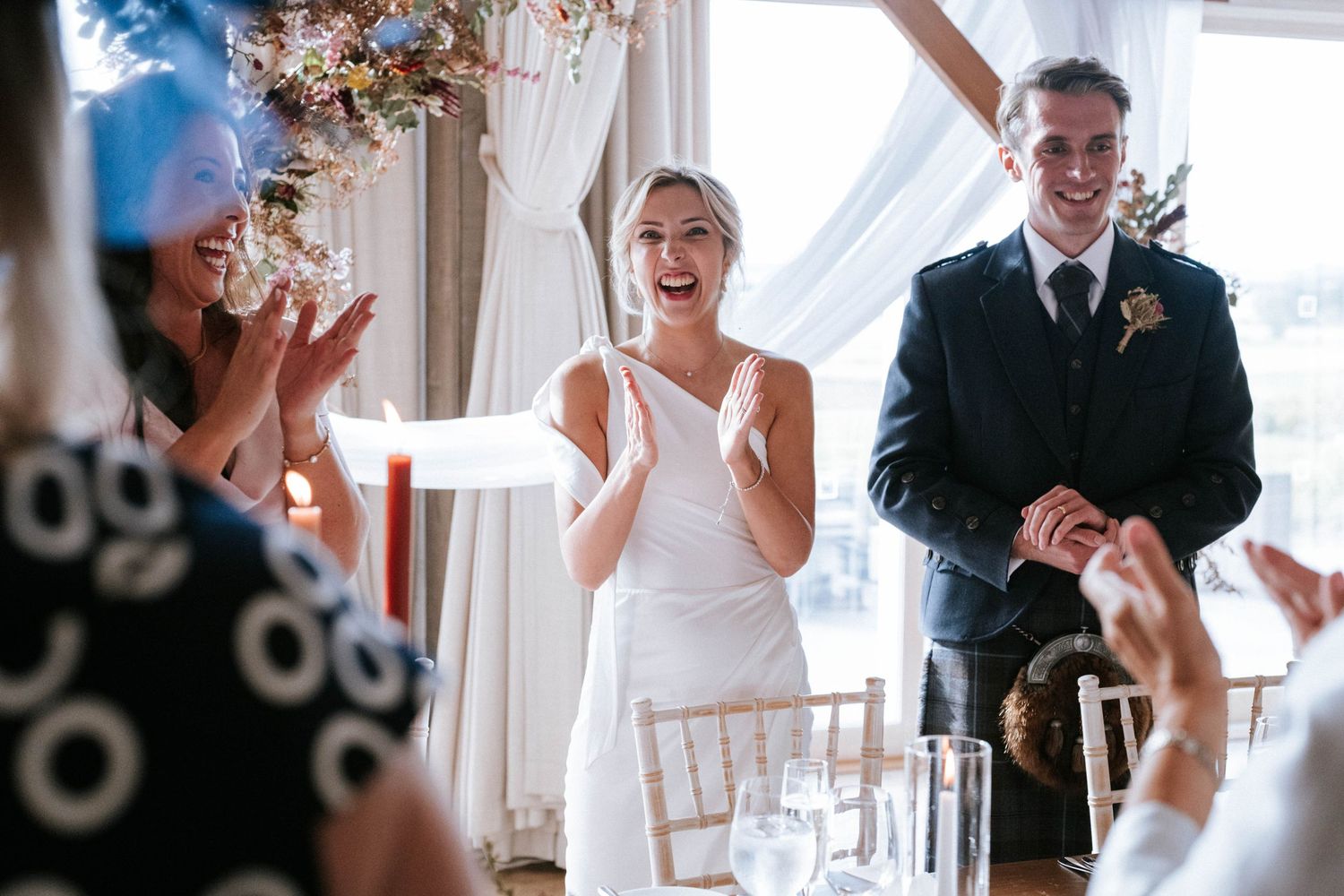 Joyful wedding celebration moments captured in bright indoor venue.
