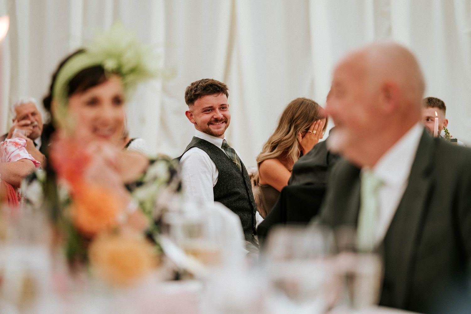 Candid moment during a wedding reception showing guests enjoying the celebration.