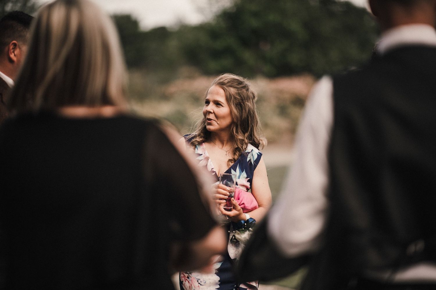 Wedding guests mingling and socializing during an outdoor reception.