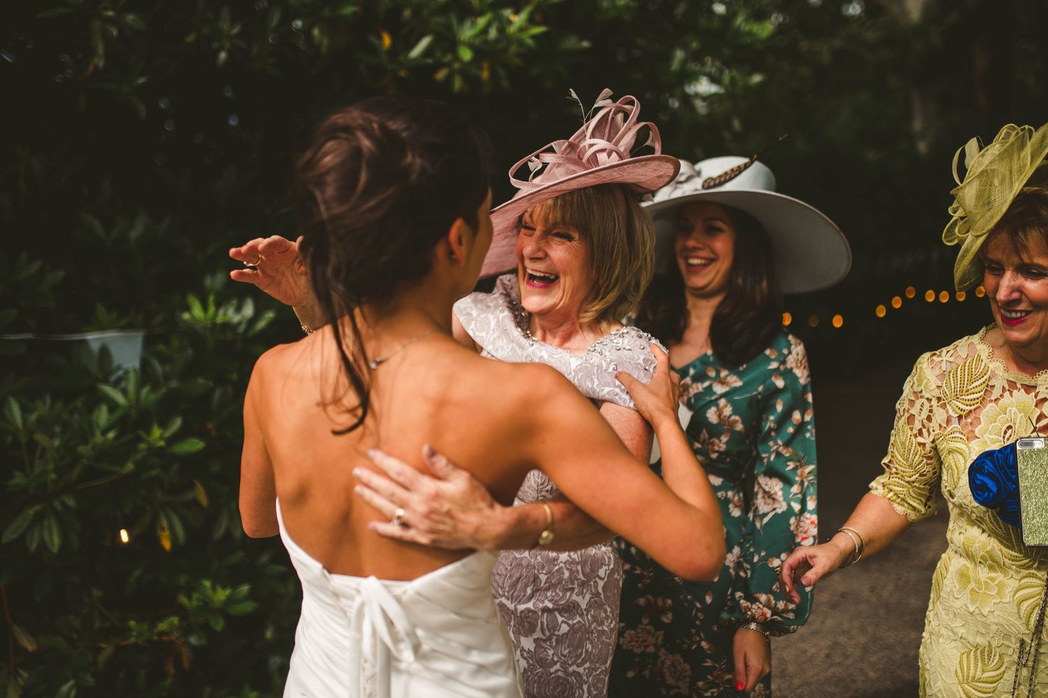 Emotional moment shared between wedding attendees during outdoor celebration.