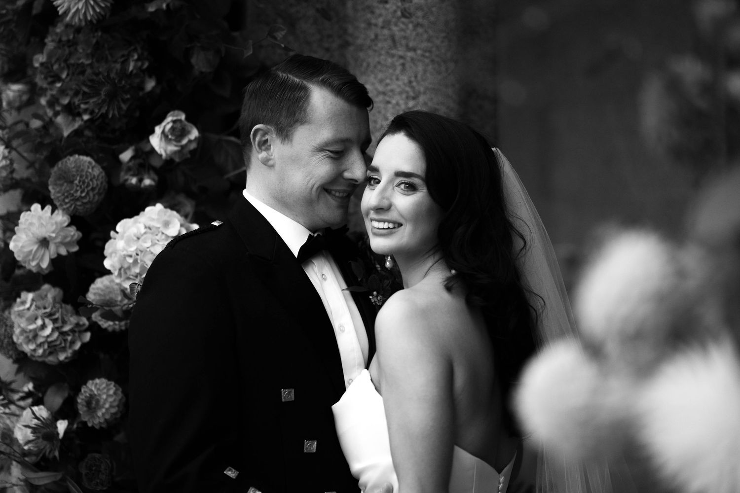 Black and white intimate wedding portraits with soft focus and romantic lighting.