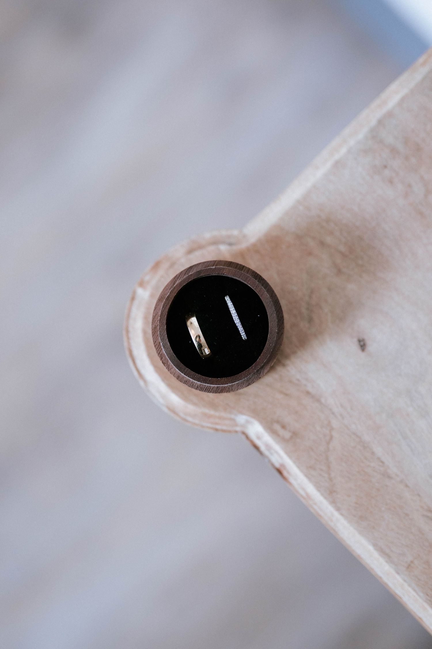 Close-up sequence of a small black hole or opening in a light colored surface.