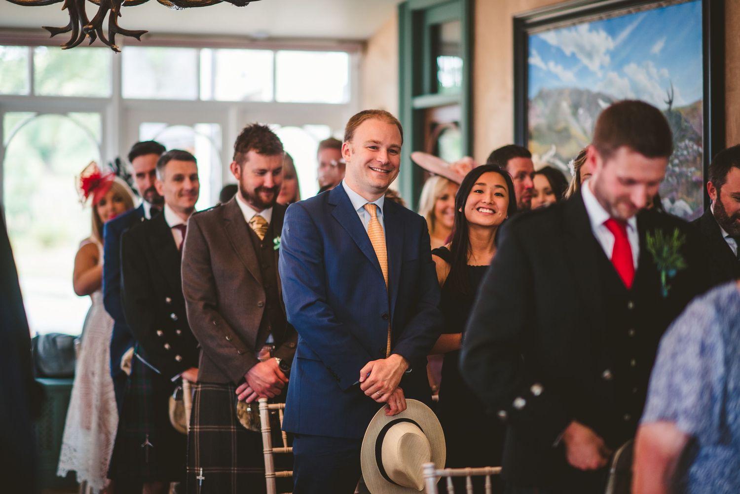 Wedding guests mingle and celebrate in a spacious reception venue.