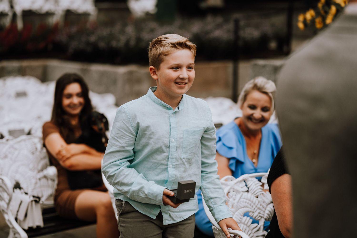 Wedding guests enjoying a lighthearted moment during an outdoor celebration.