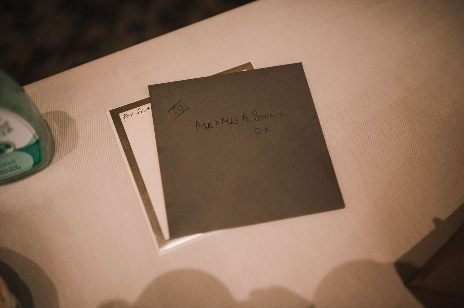 Dark menu cards on a light colored surface in ambient lighting.