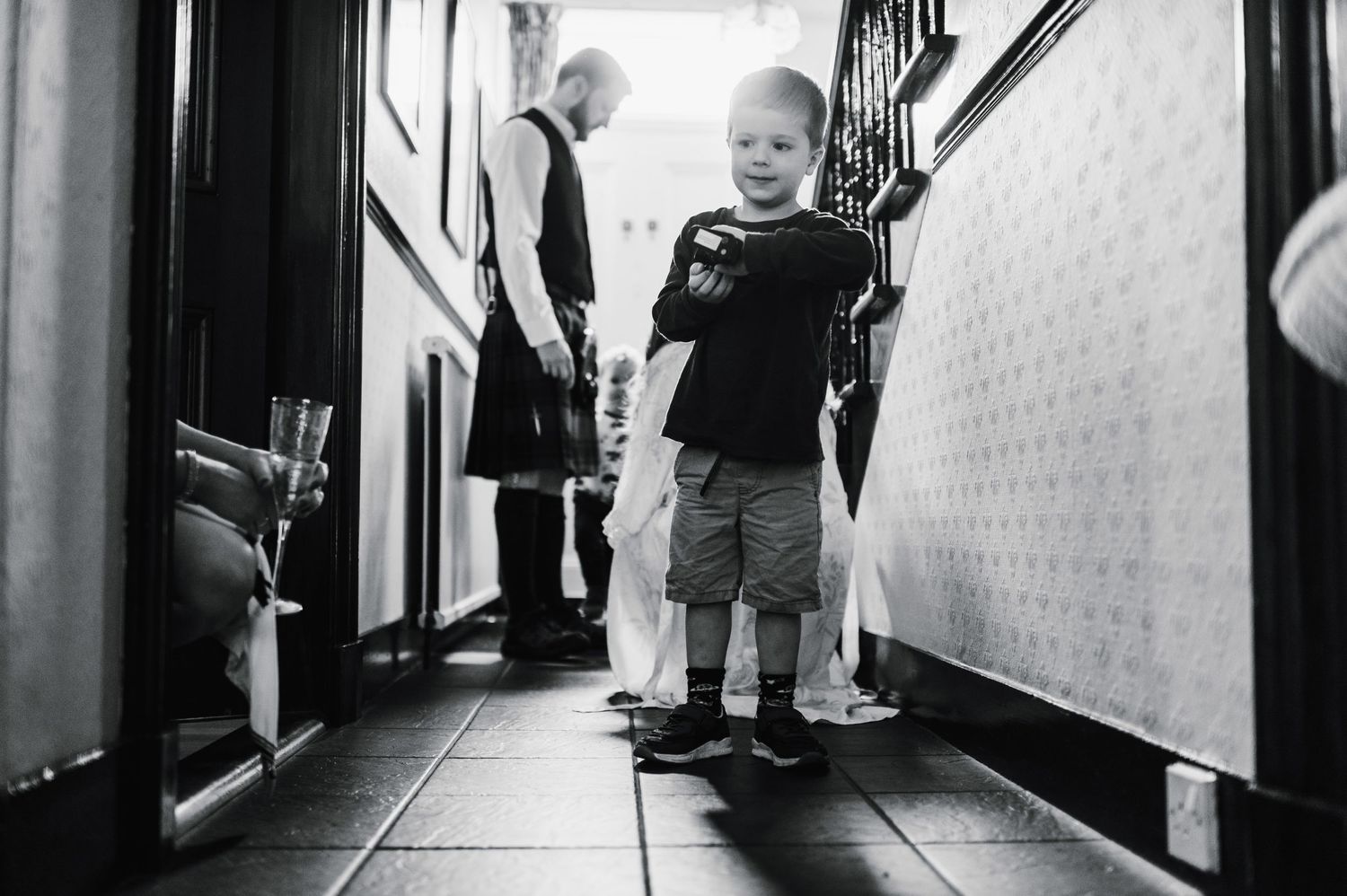 Black and white candid shot of a child in a hallway.