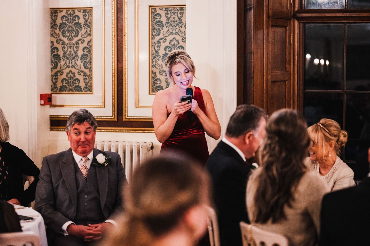 Guest giving emotional speech during formal dinner reception.