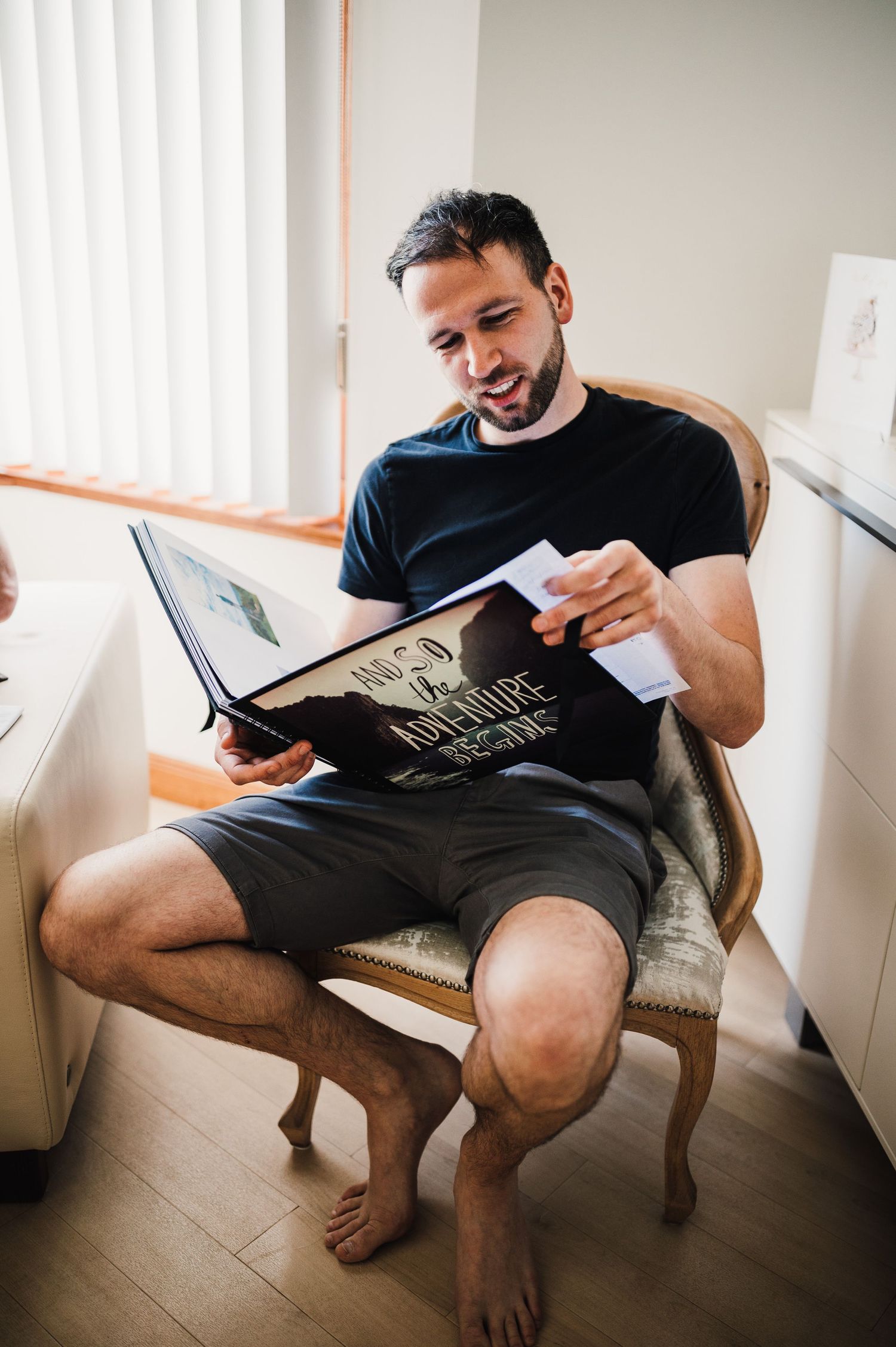 Someone relaxing in a chair while reading a book.