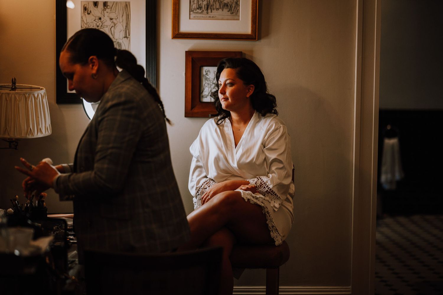 A quiet moment during wedding preparations with people in a traditionally furnished room.