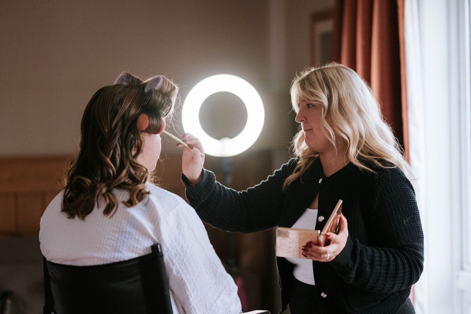 Behind the scenes preparation moments during a wedding day with professional lighting equipment.