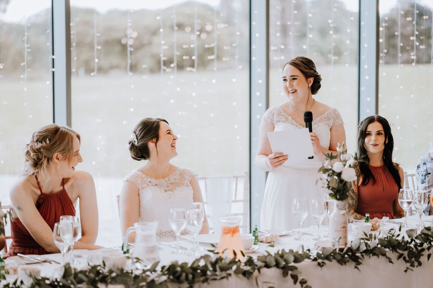 Wedding reception table decorated with greenery garlands and place settings. Meldrum House Wedding Photography.