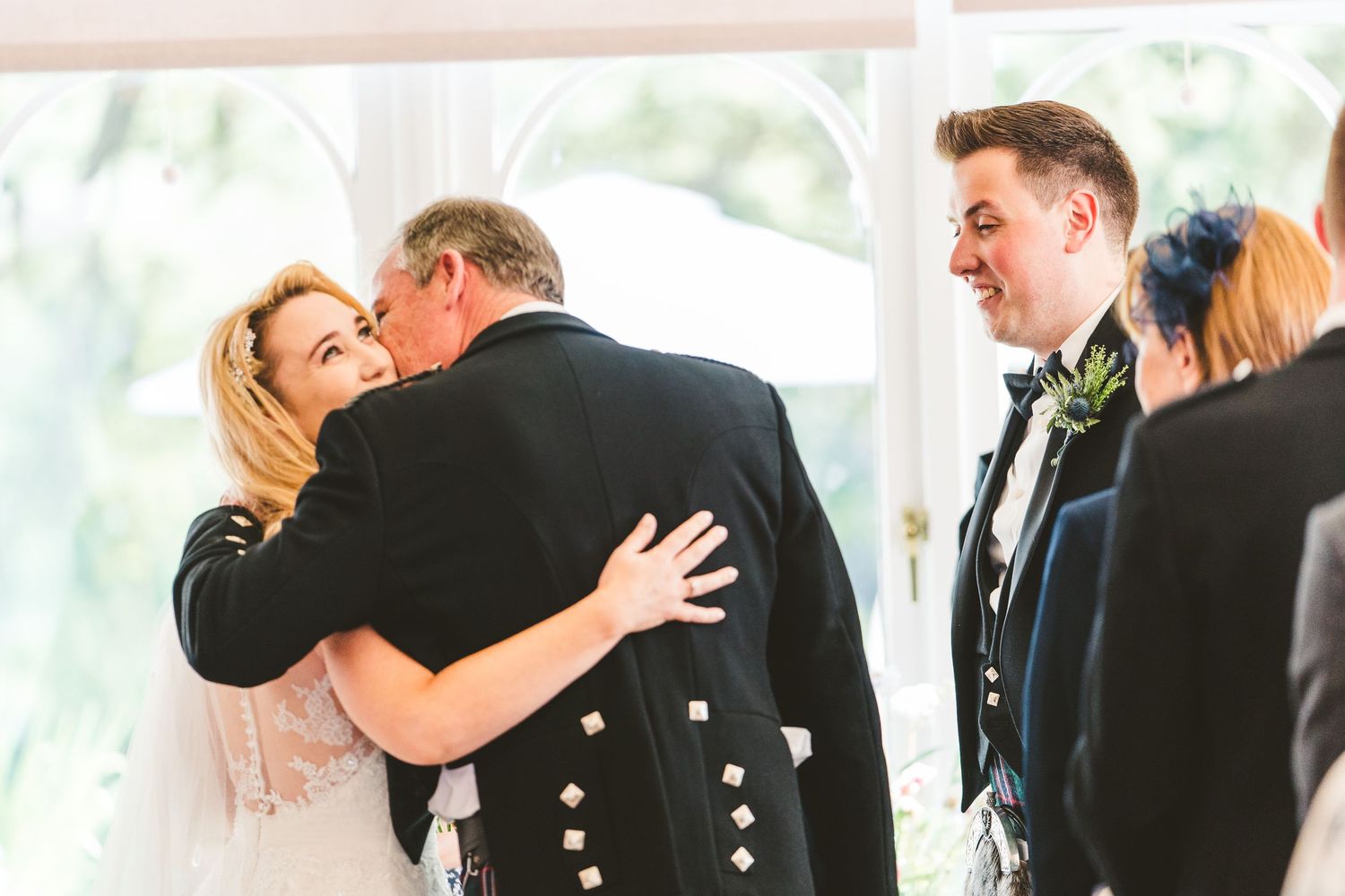 Intimate wedding ceremony moments captured indoors with natural lighting.