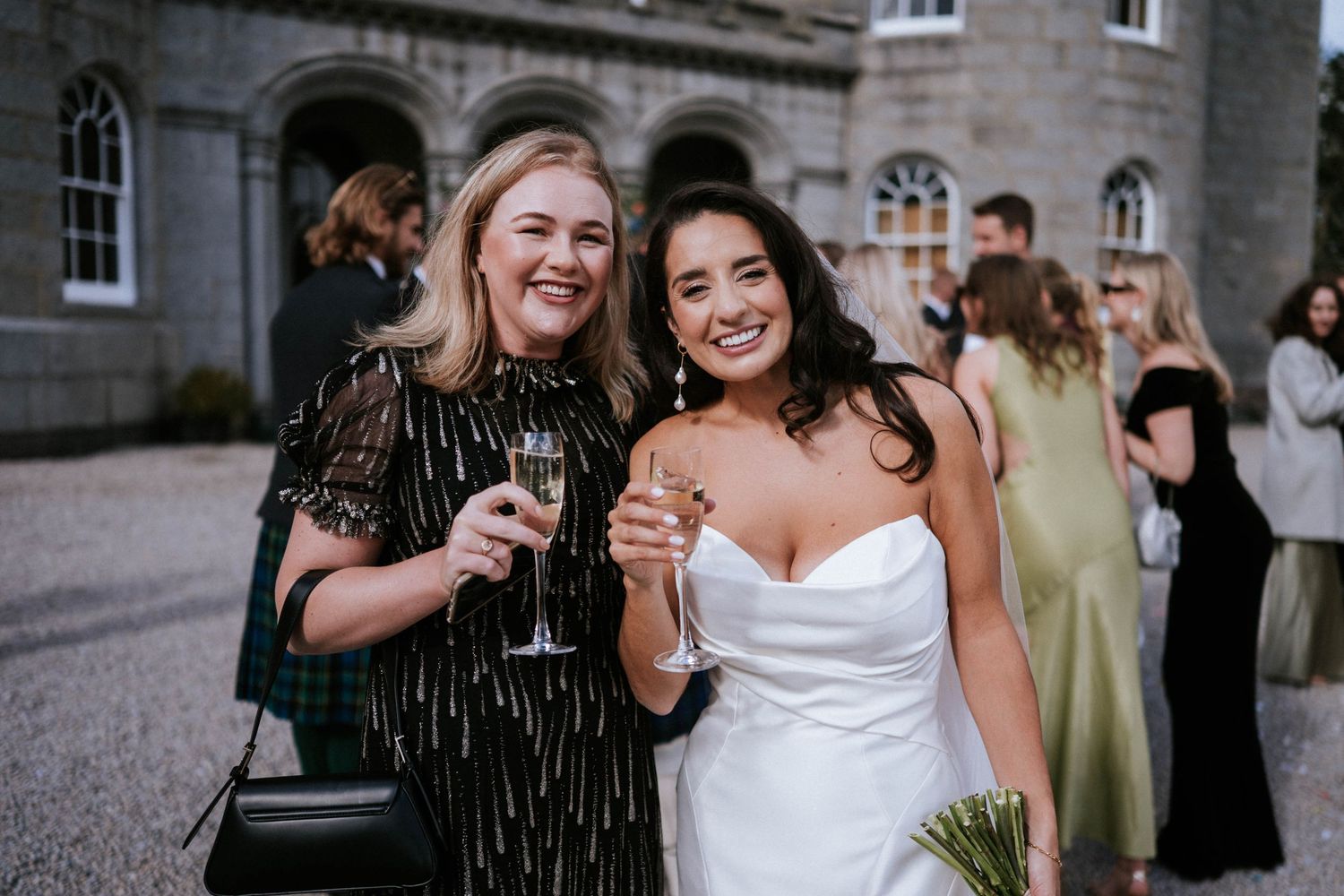Celebratory moment at wedding reception with champagne and laughter.