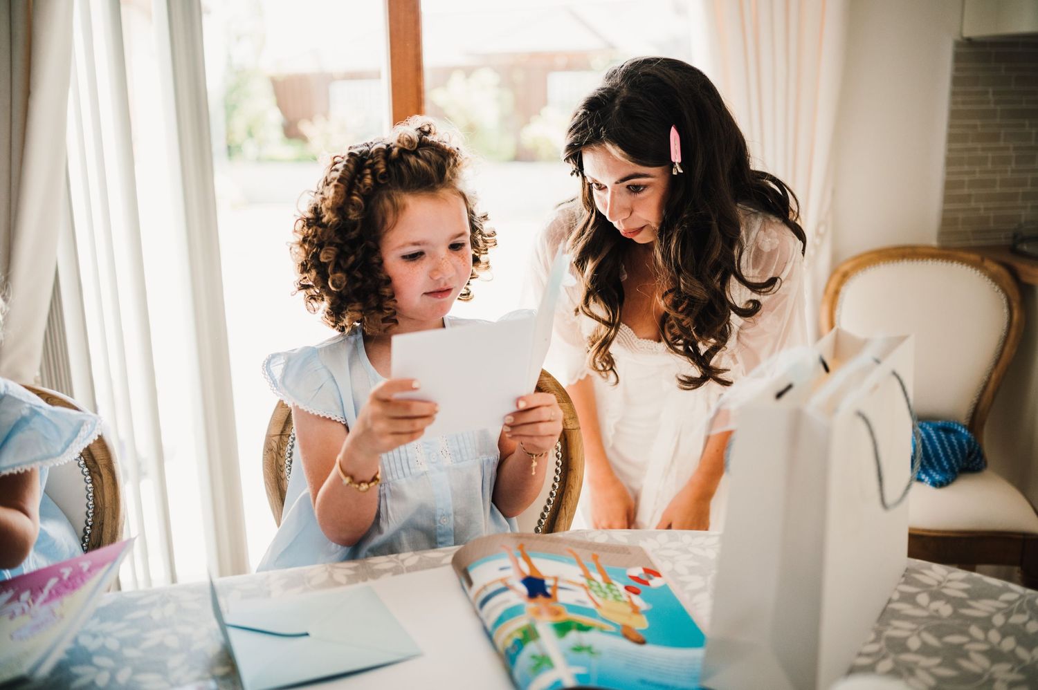 Two people sharing a moment while looking at papers during wedding preparations.