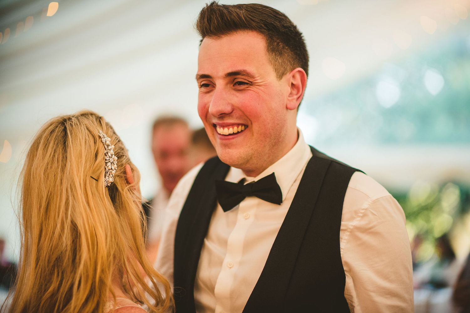 Wedding reception candid moments captured under elegant indoor lighting.