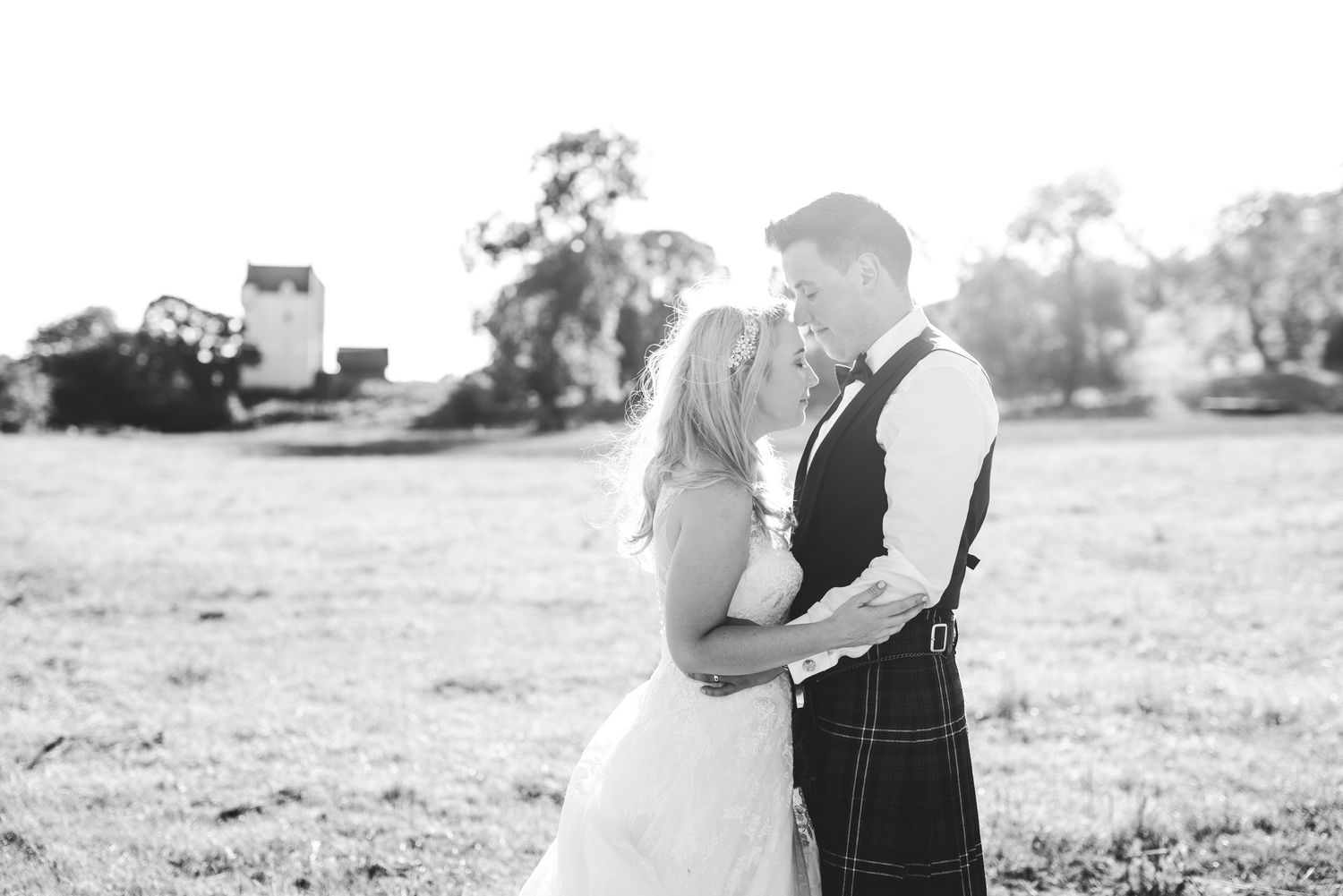 A black and white photo collage shows intimate moments of a couple during their outdoor engagement session.