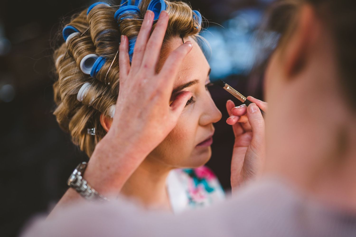 Emotional wedding preparation moment with delicate boutonnieres and floral details.