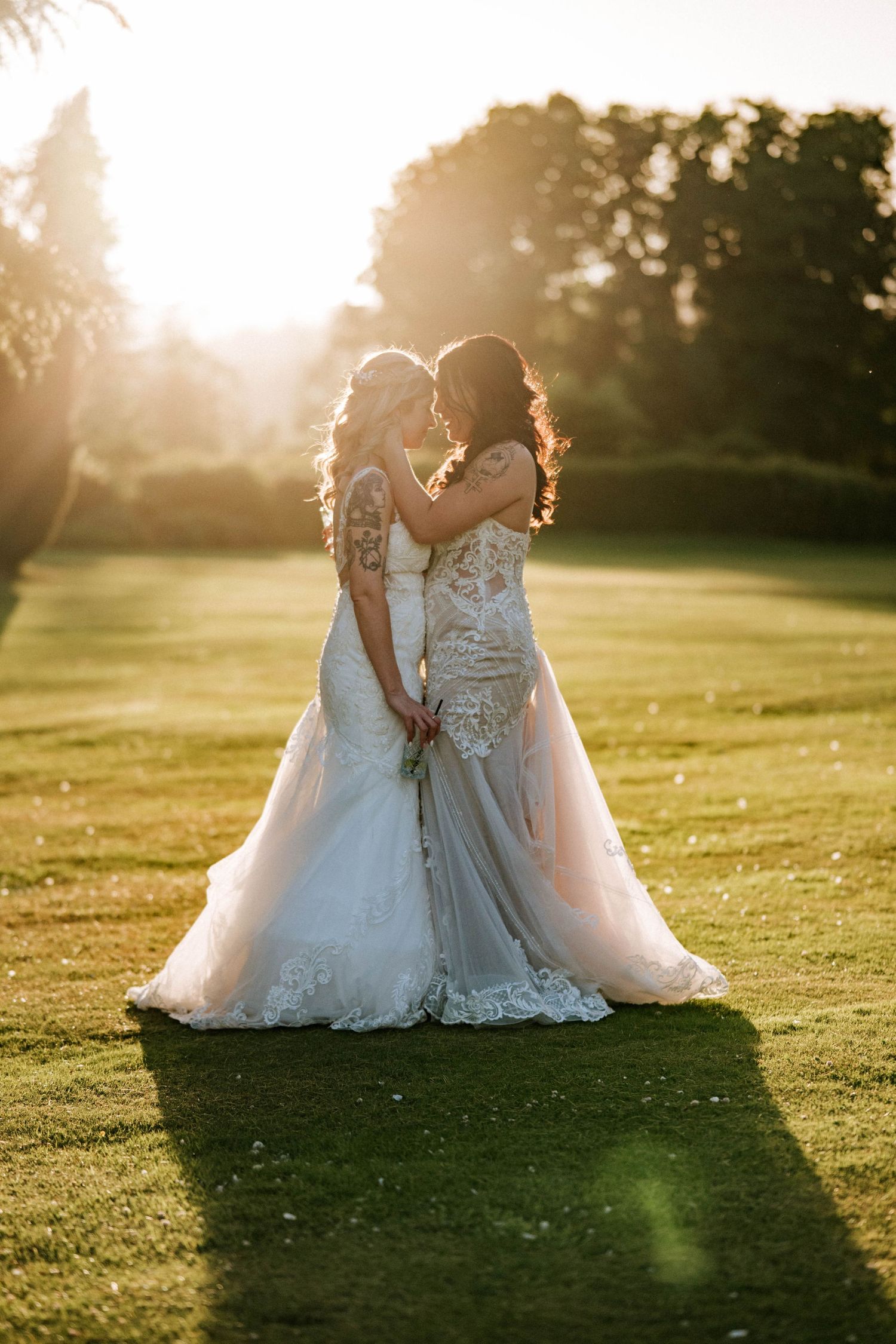 Aberdeen Wedding Photography. Wedding photo at sunset with golden light streaming across a green lawn.