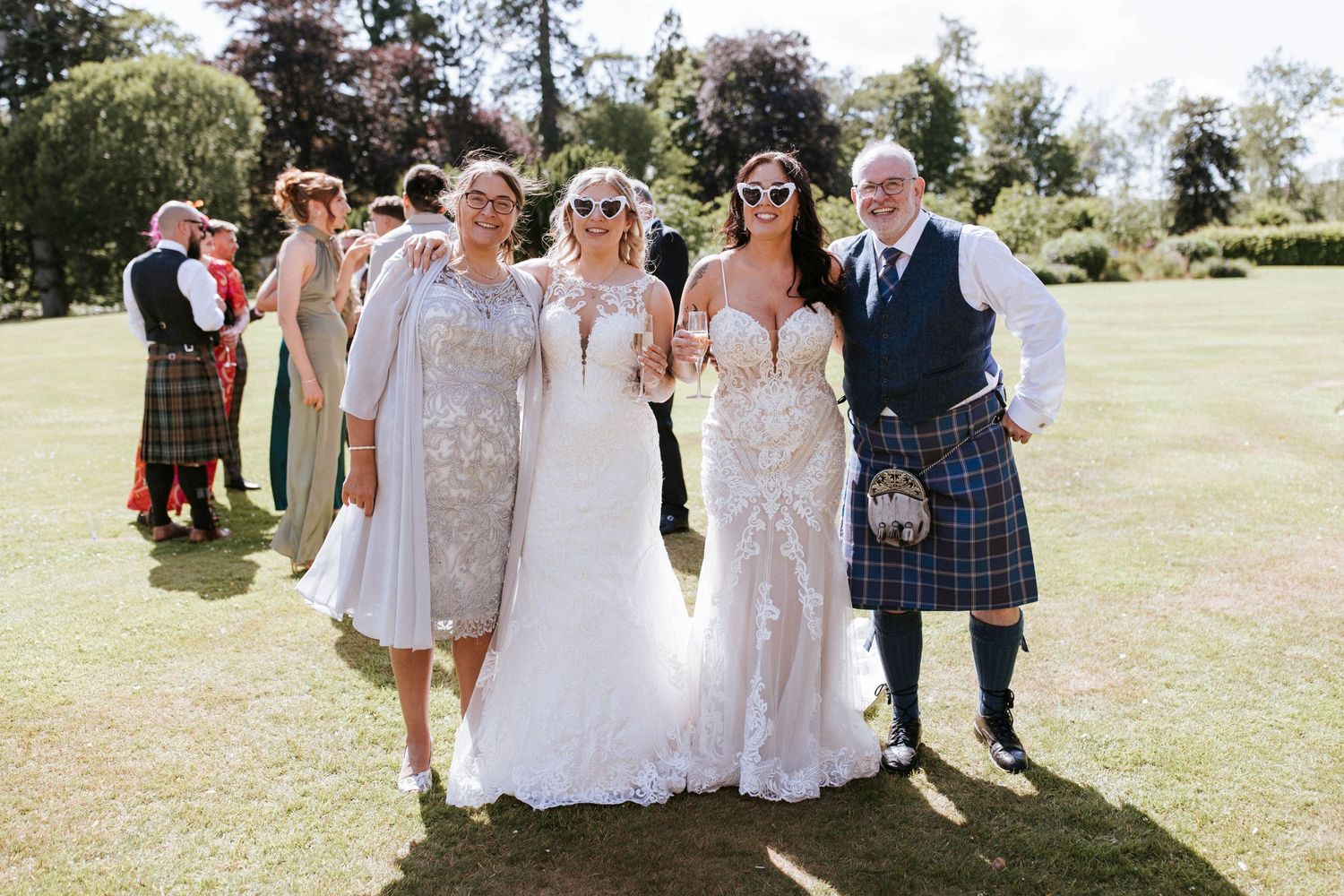 Fasque Castle Wedding Photography. Wedding party poses for group photos outdoors on sunny day.