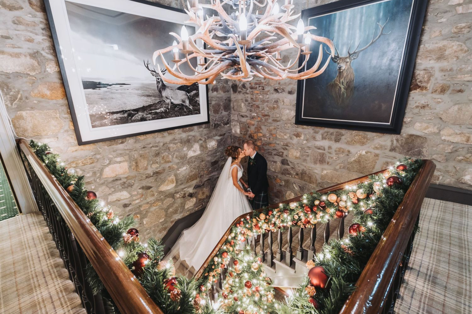 A rustic stone staircase decorated with greenery and floral arrangements for a wedding ceremony.