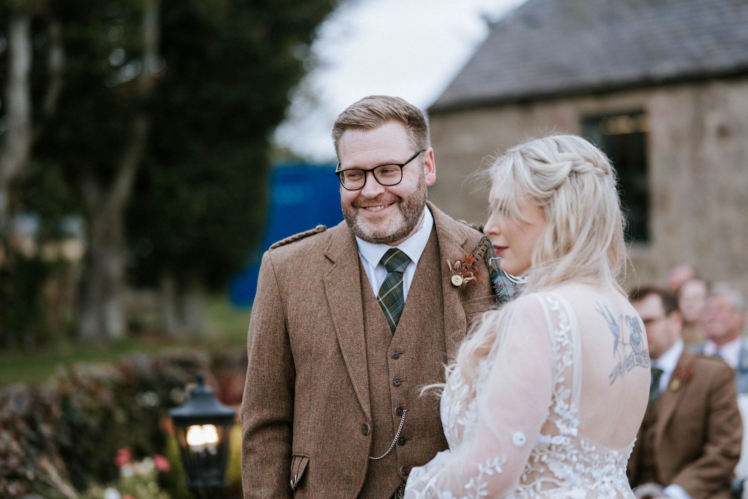 A tender moment captured between a couple during their wedding ceremony outdoors.