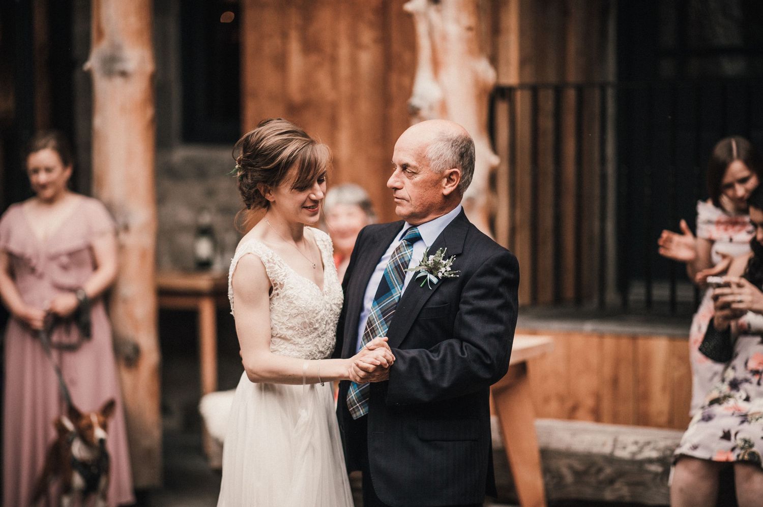 Emotional moment during wedding dance in courtyard setting.