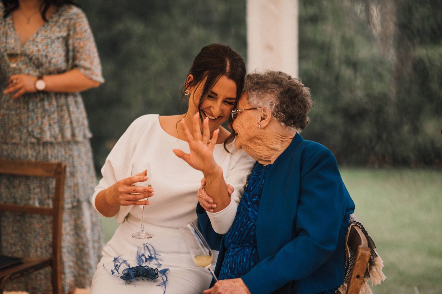 A heartwarming moment shared between guests at an outdoor wedding celebration.
