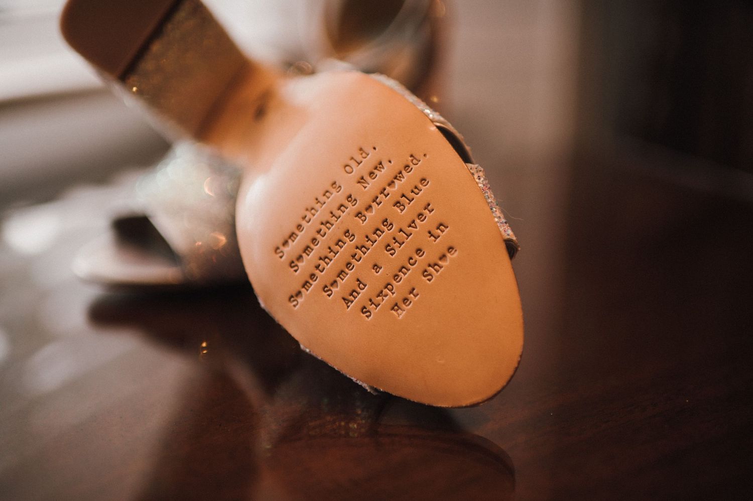 Close-up shot of handwritten text on the sole of a shoe.