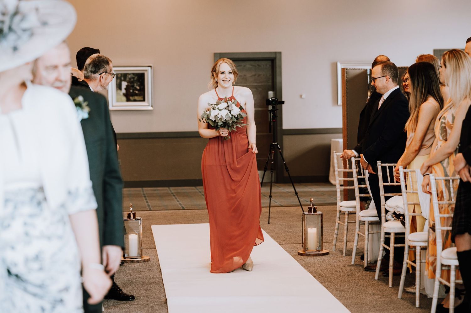 A Scottish wedding ceremony processional with traditional kilts and formal wedding attire.
