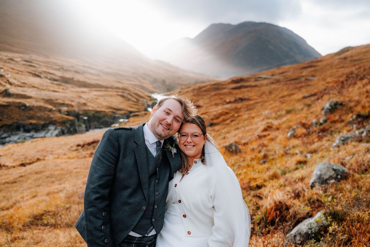 Romantic wedding portraits in the rugged Scottish Highlands with moody autumn colors.