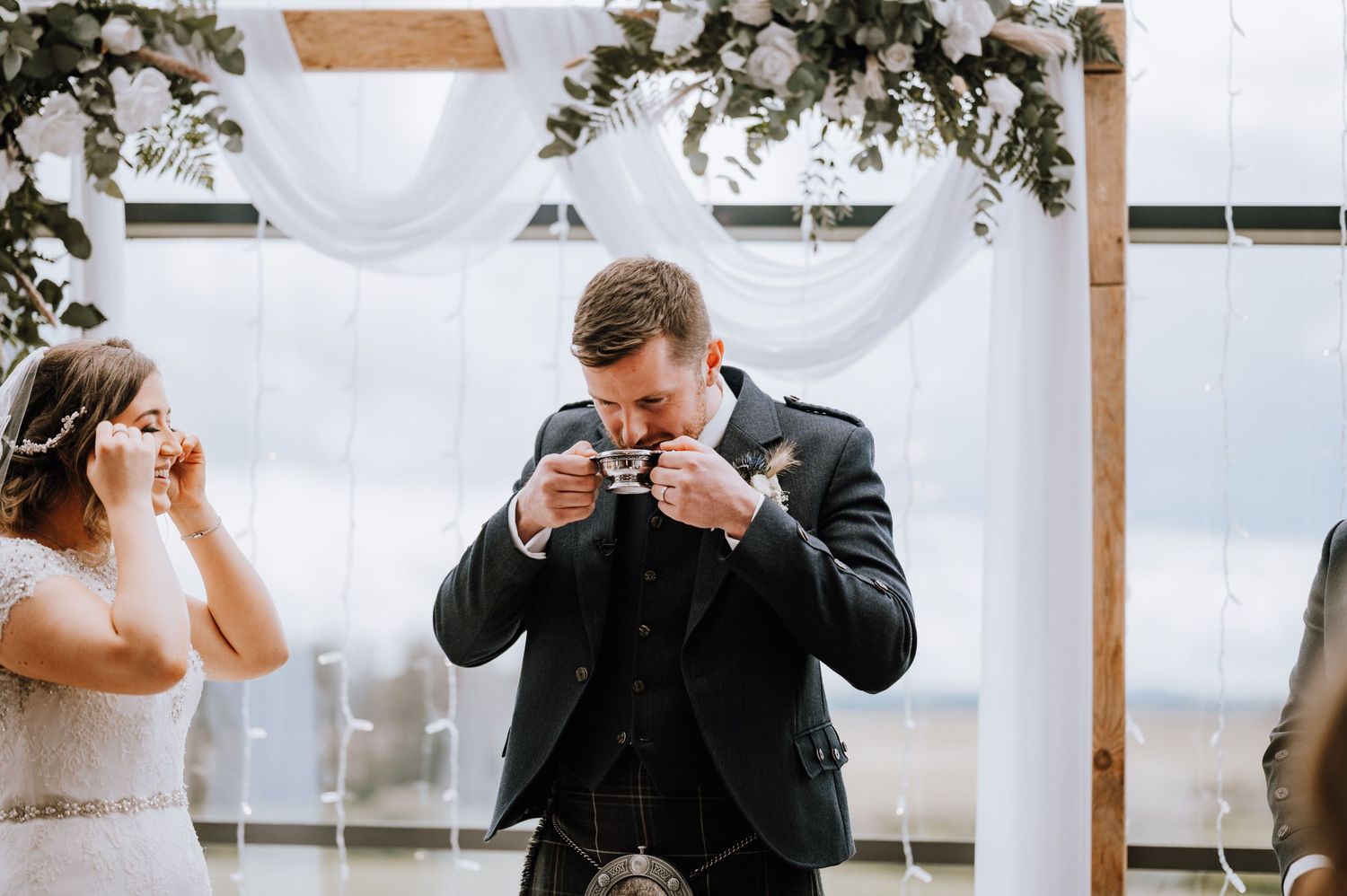 An emotional moment during the wedding ceremony with reactions to vows or speeches.