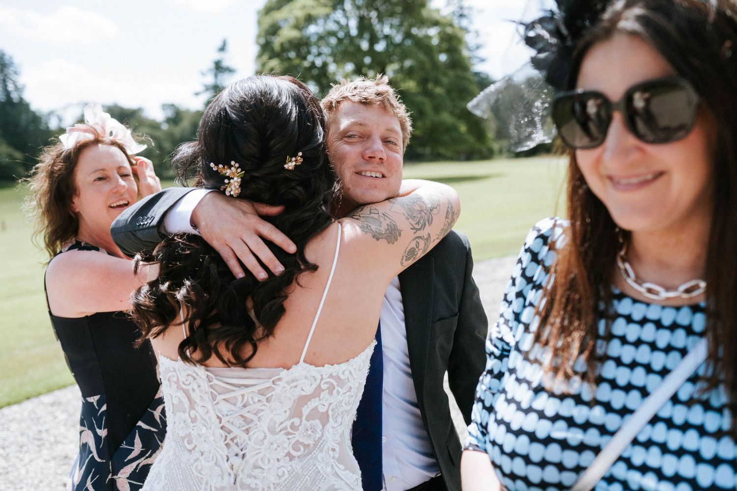 Wedding guests mingle and chat during outdoor summer reception.