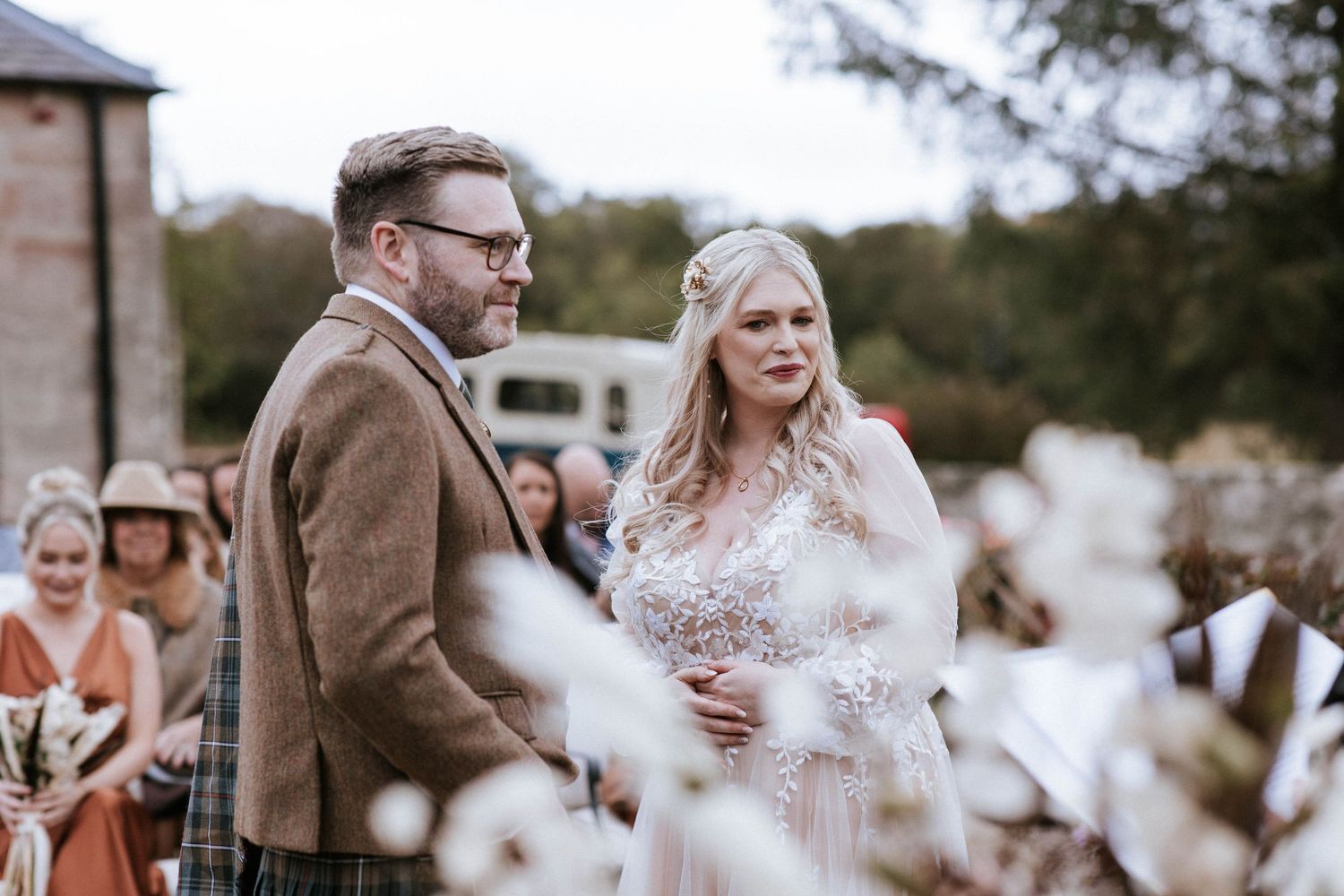 Couple sharing a moment during their Scottish wedding ceremony outdoors.