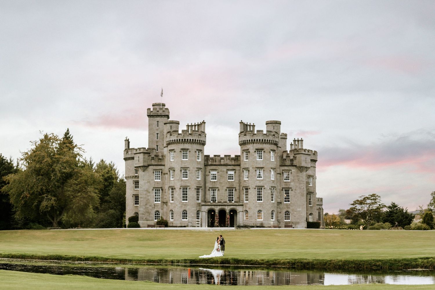 Panoramic view of a grand Scottish castle wedding venue with sprawling grounds.