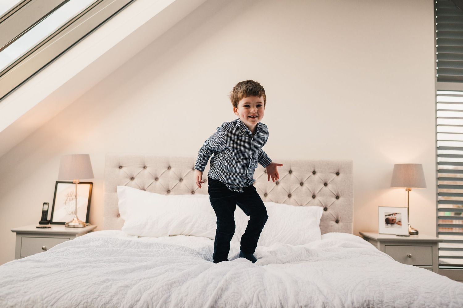 A sequence of photos showing someone jumping and playing on a white bed in a bright modern bedroom.