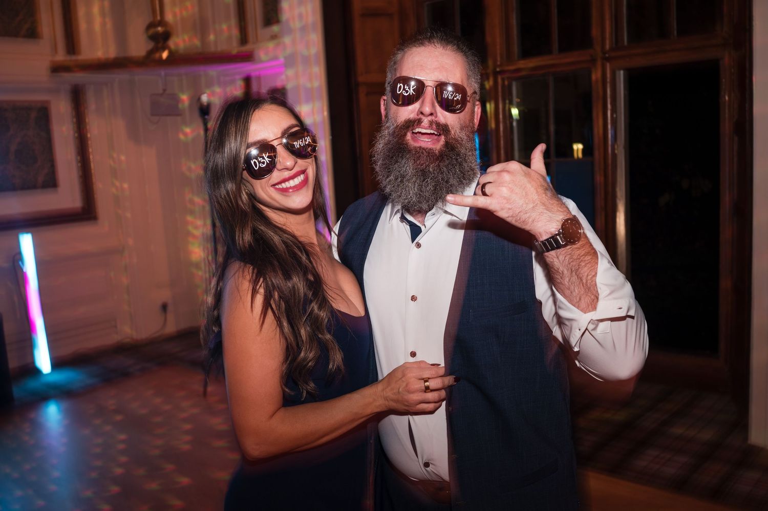 Aberdeen Wedding Photography. Party guests wearing sunglasses dance and celebrate at an indoor reception.