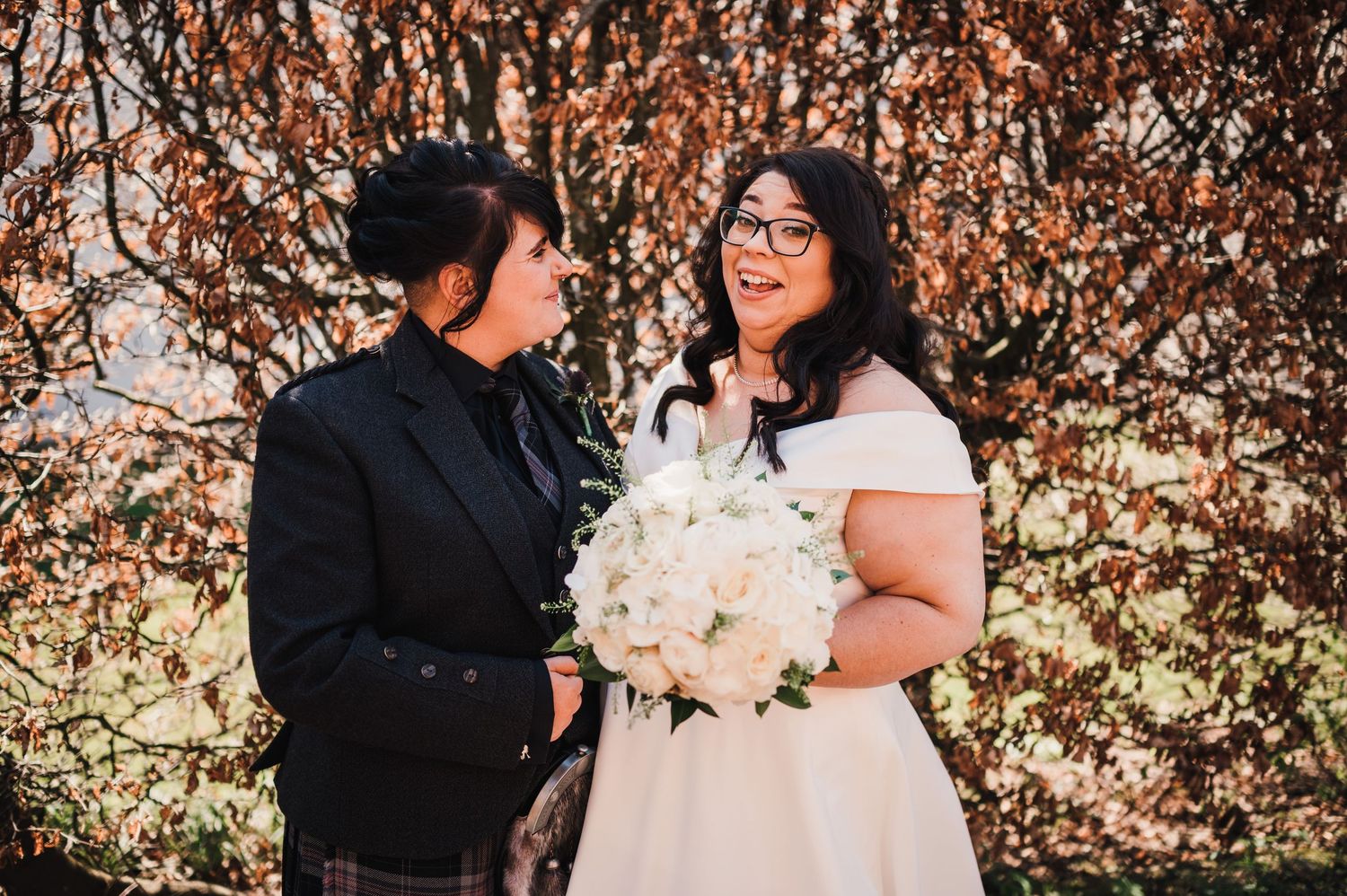 Logie House Wedding Photography. Autumn wedding portrait with orange foliage in the background.