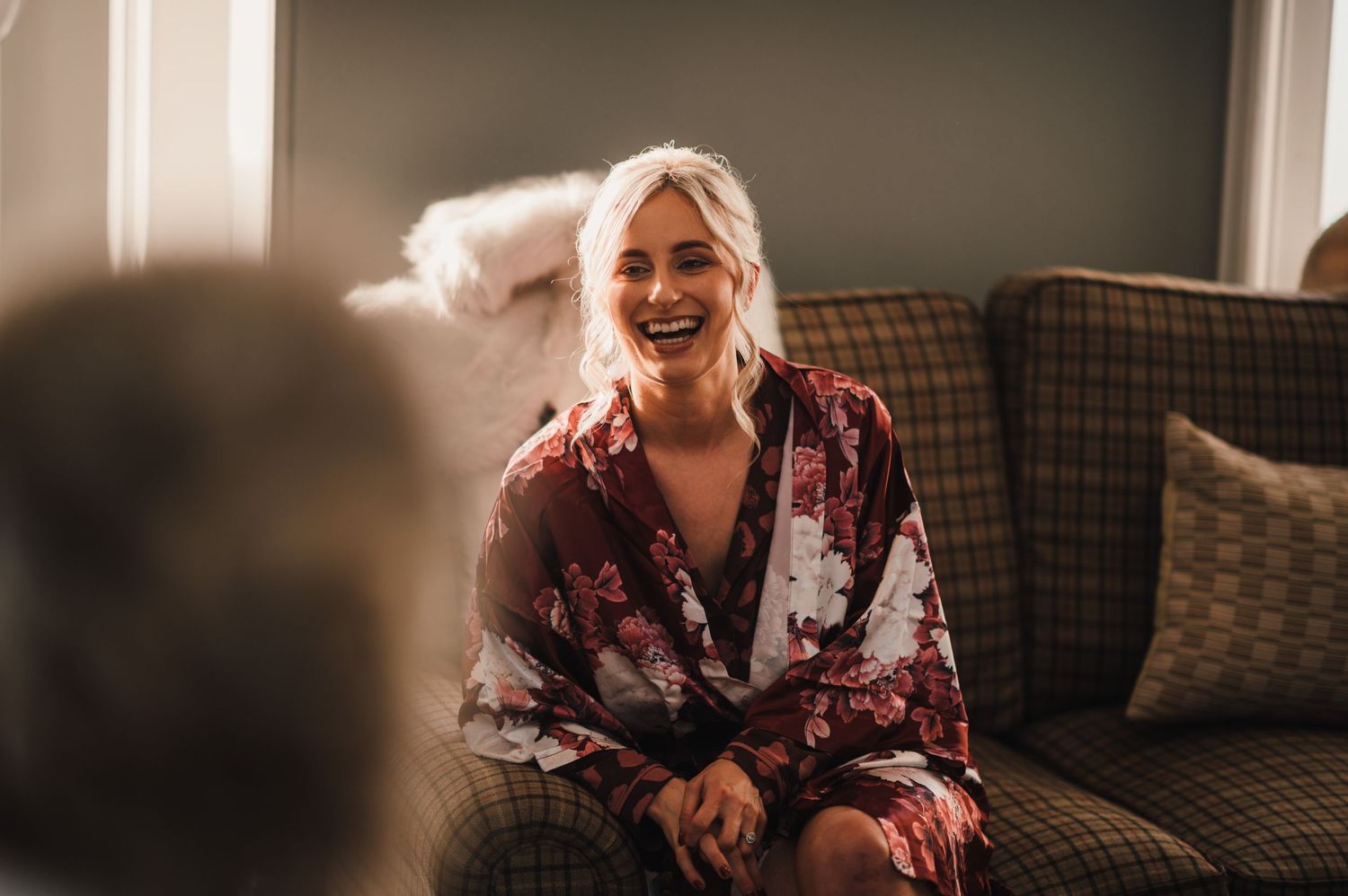 A candid moment of laughter and joy during wedding preparations.